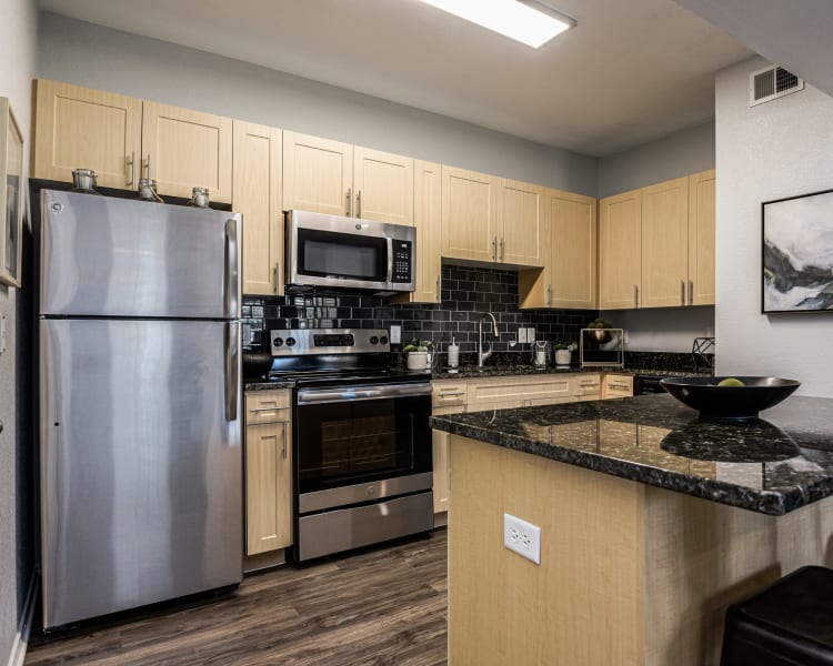 Spacious kitchen with plenty of granite countertop space at Ranch ThreeOFive in Arlington, Texas