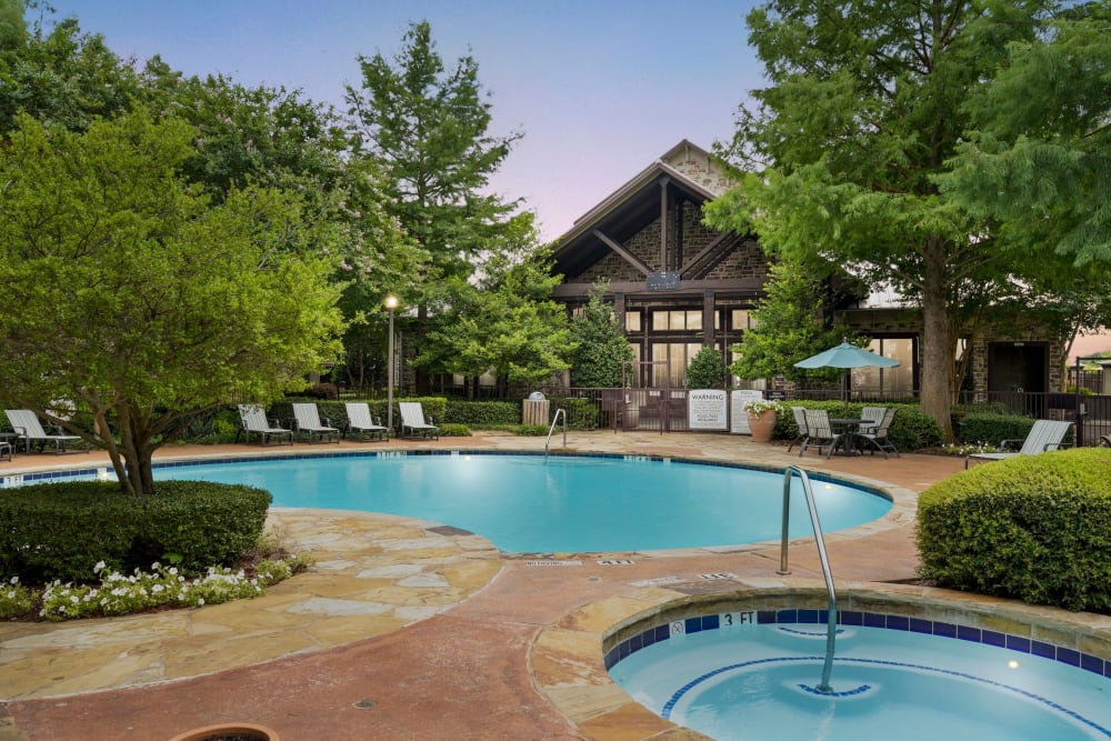 Beautiful pool with a sundeck and a forest backdrop at Ranch ThreeOFive in Arlington, Texas