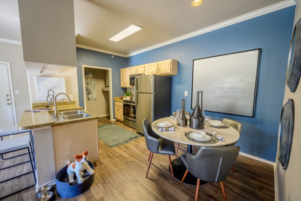 Dining area next to the kitchen with an accent wall in a model apartment at 23Hundred @ Ridgeview in Plano, Texas