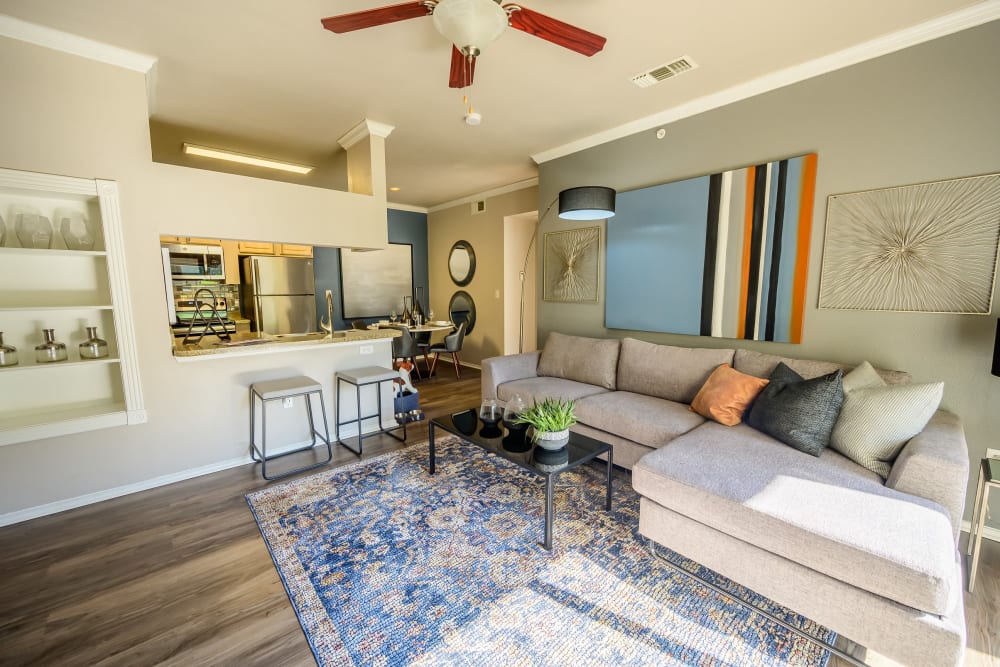 Built-in shelving and modern furnishings in a model apartment's living area at 23Hundred @ Ridgeview in Plano, Texas