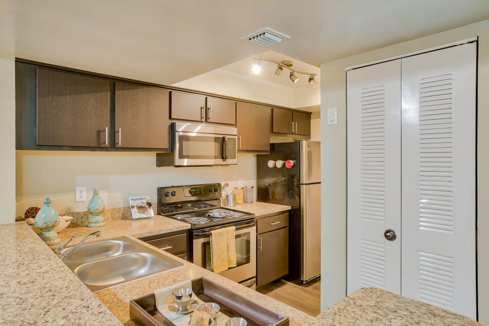 Model kitchen with updated appliances at Village Place Apartment Homes in West Palm Beach, Florida