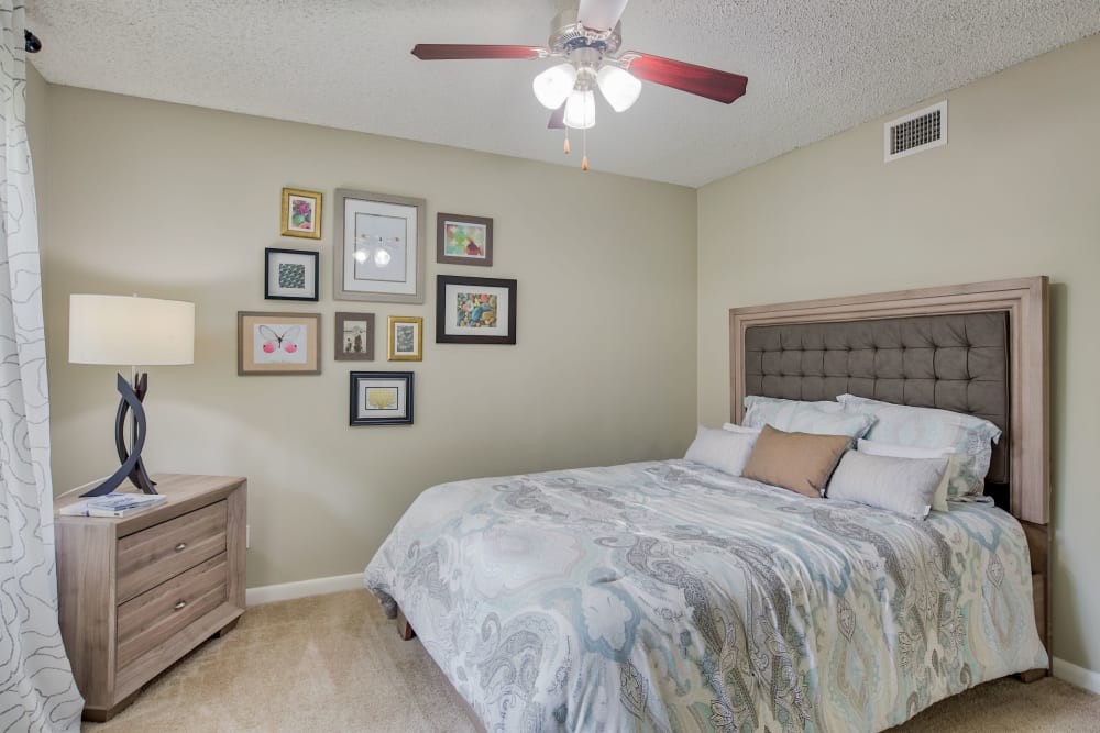 Model bedroom with ceiling fan at Village Place Apartment Homes in West Palm Beach, Florida