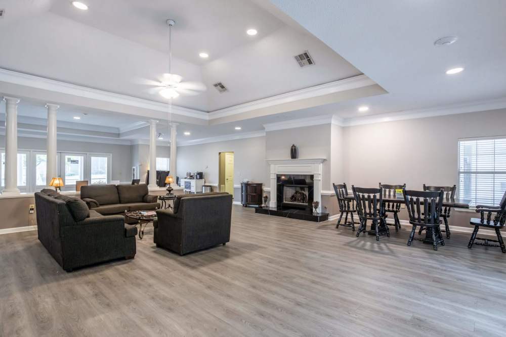 Resident lounge area with fireplace and dining area at Brittany Place Lagrange in LaGrange, Georgia
