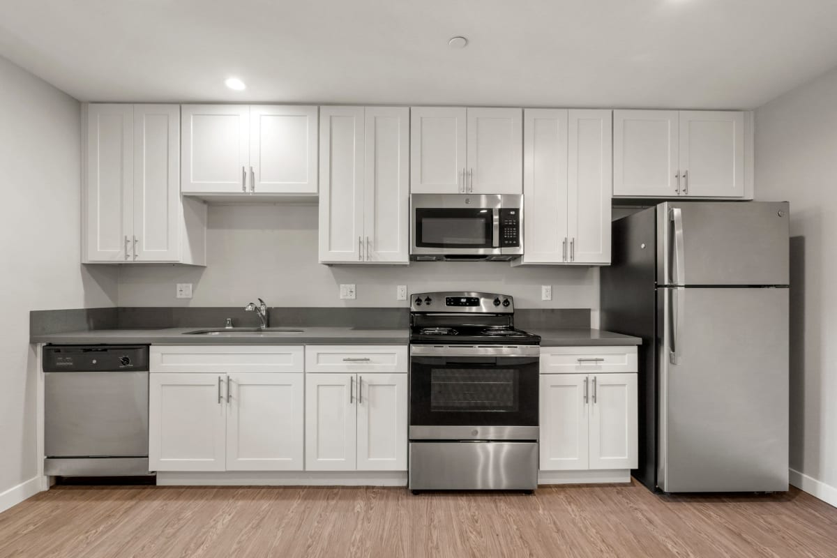 Kitchen with wood-style floor at Los Robles Apartments, Thousand Oaks, California