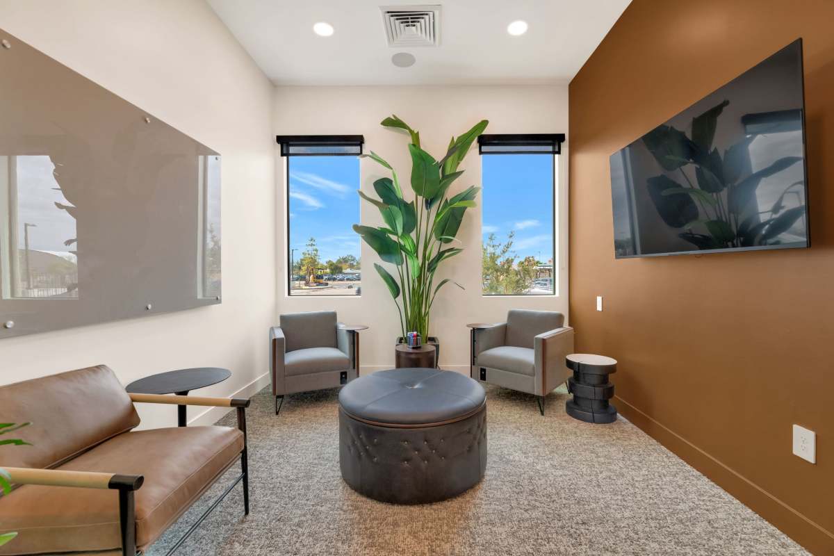 Clubroom with lounge seating and TV at Hangar at Thunderbird, Glendale, Arizona