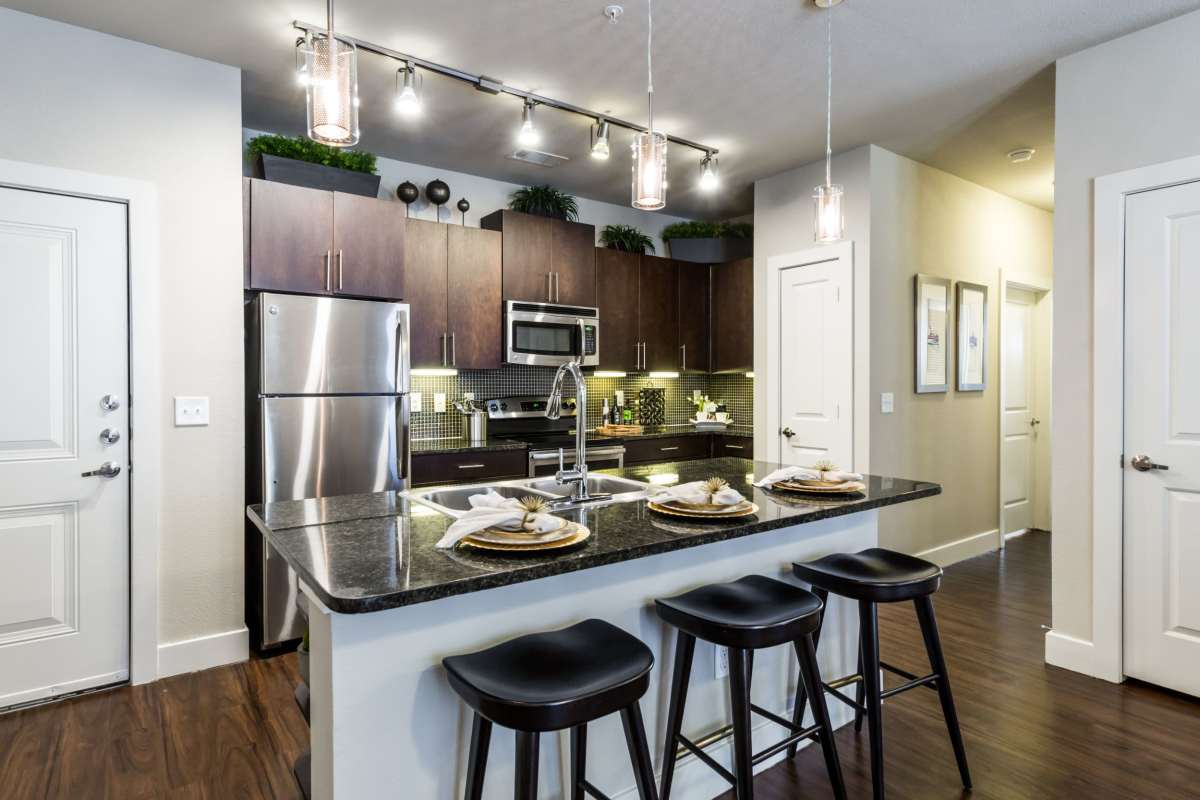 Kitchen with stainless-steel appliances at Grand at the Dominion Apartments, San Antonio, Texas