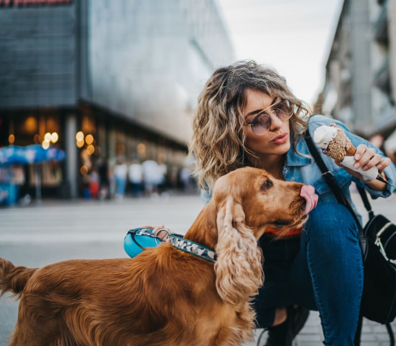 Resident petting her dog outside of Marq 211 in Seattle, Washington