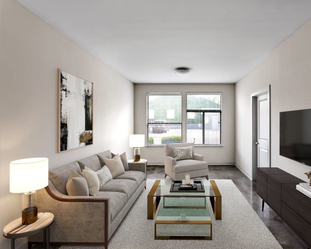 Large open-concept living area with hardwood flooring in a model home at Olympus Midtown in Nashville, Tennessee
