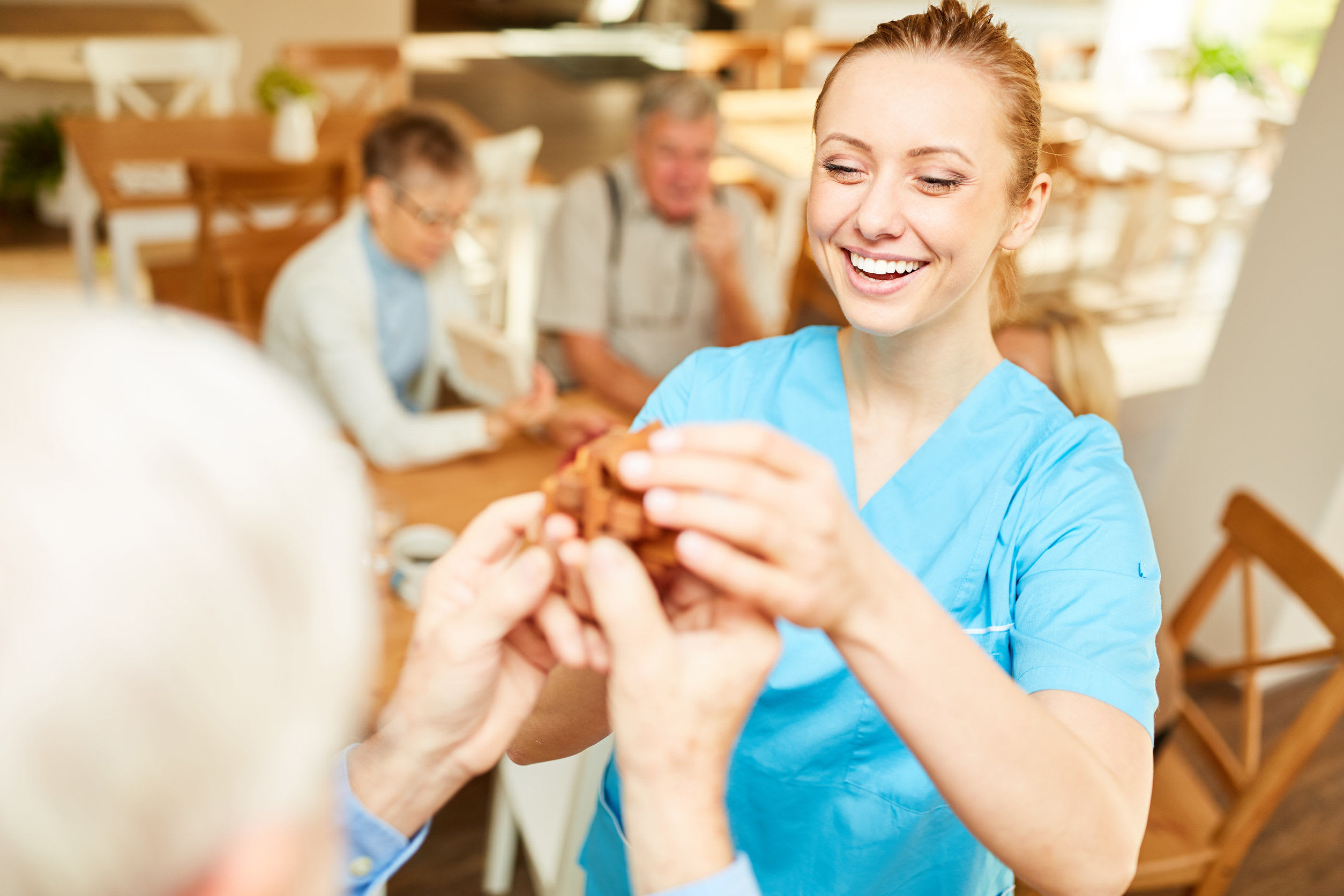 Resident and smiling caregiver at Wellington Place at Fort Atkinson in Fort Atkinson, Wisconsin