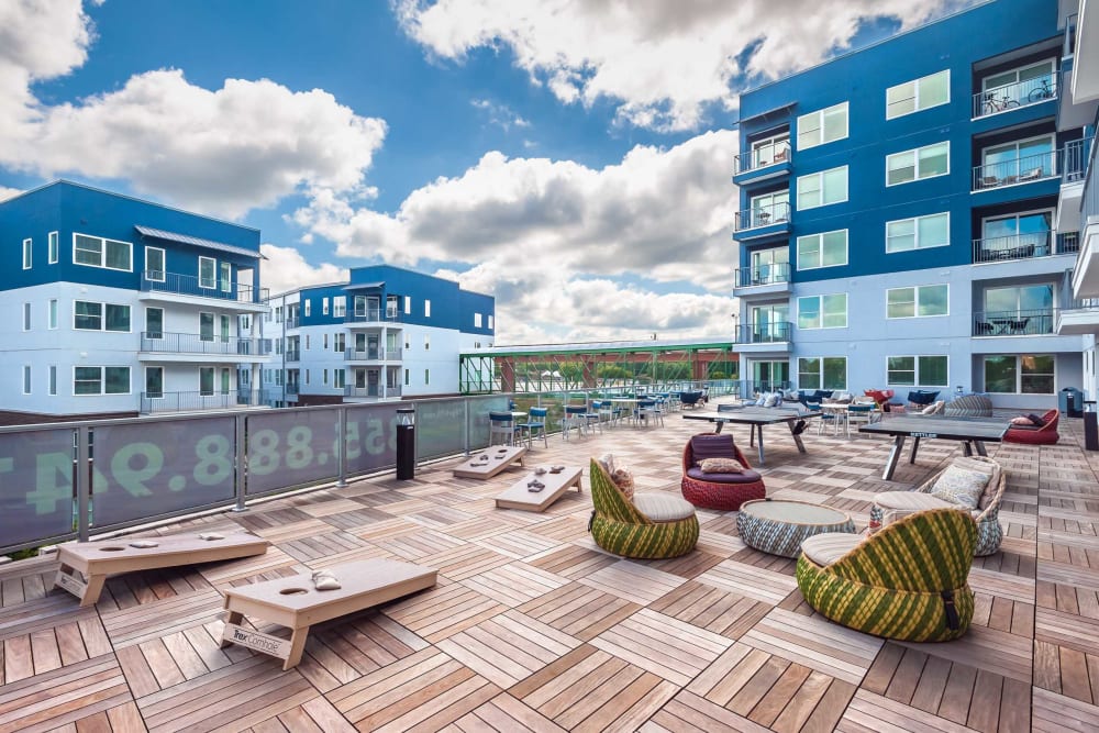 Outdoor lounge with ping pong tables and corn hole at EDGE on the Beltline in Atlanta, Georgia
