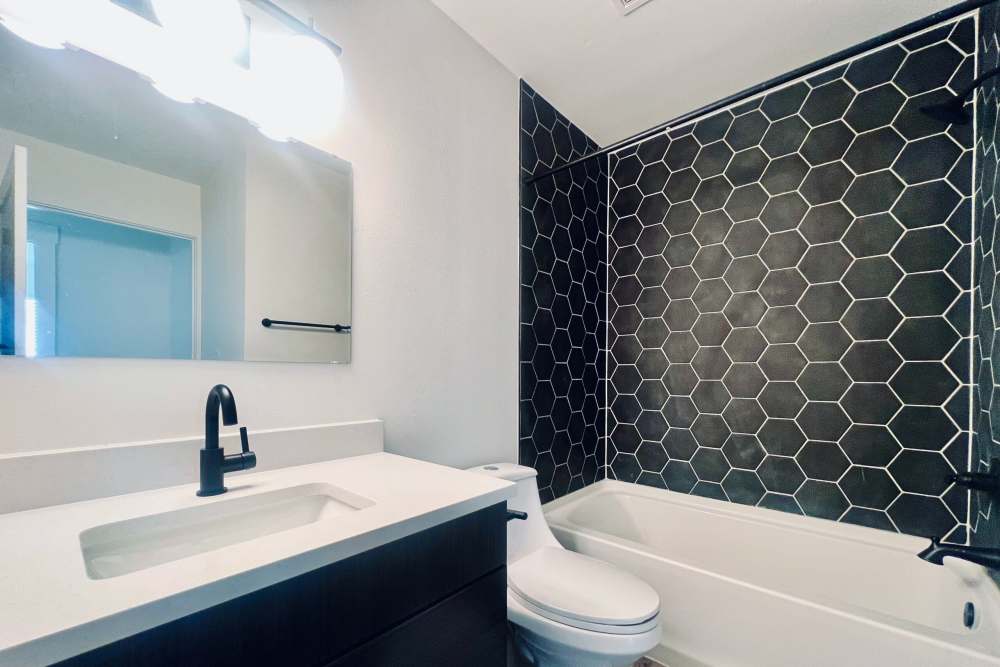 Bathroom  with vanity mirror light at Quail Run in Oklahoma City, Oklahoma 
