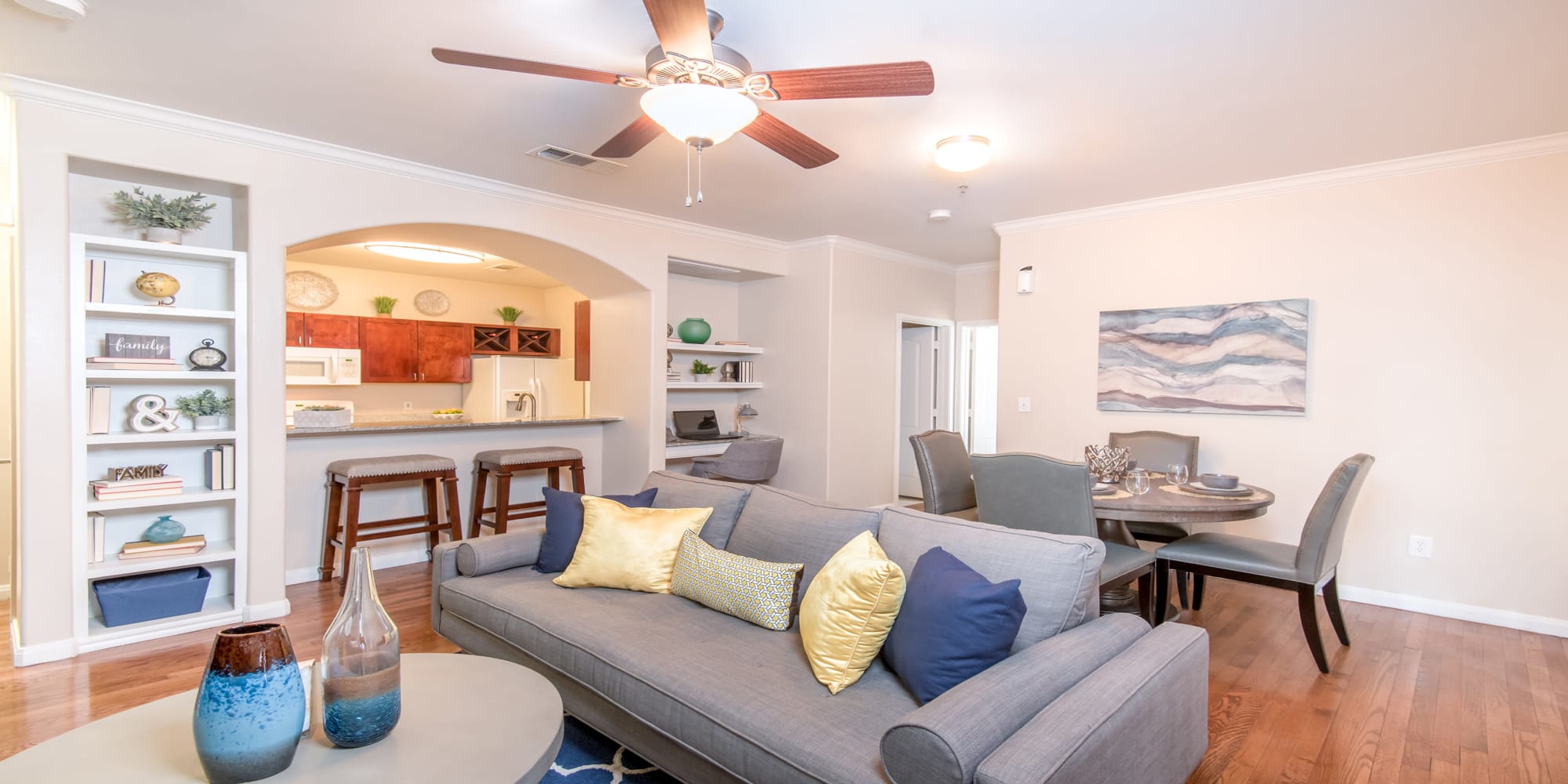 Living room layout with hardwood floors at Chateau de Ville