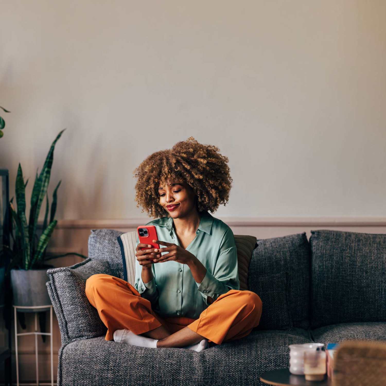 A resident using her phone to follow social media pages at The Kinsley at Perimeter Center in Atlanta, Georgia