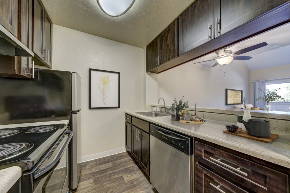 A kitchen with plenty of cabinet space at The Timbers Apartments in Hayward, California