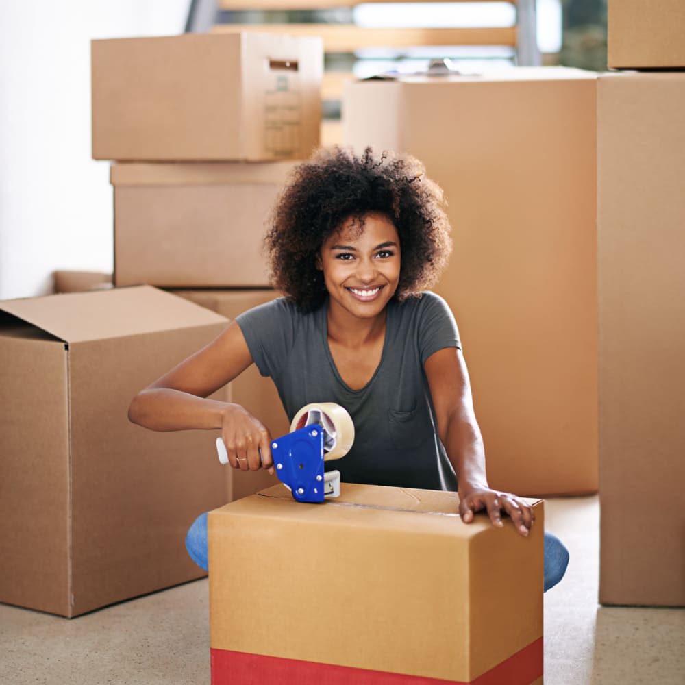 Women taping up a box at Grand Slam Self Storage in St. Louis, Missouri