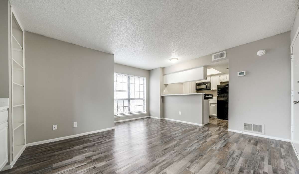 Spacious living room with large windows at Icon Apartments in San Antonio, Texas