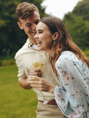 A couple laughing with wine at Ridge at 66 in Yukon, Oklahoma