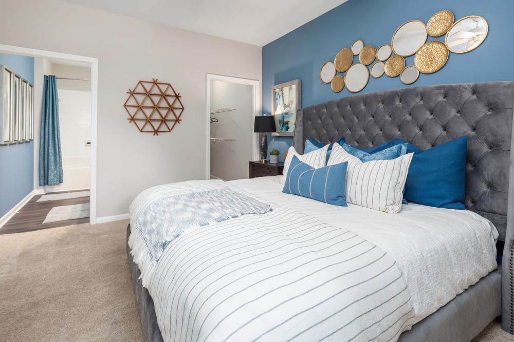 Well-furnished primary bedroom in a model home at Highlands at Alexander Pointe in Charlotte, North Carolina