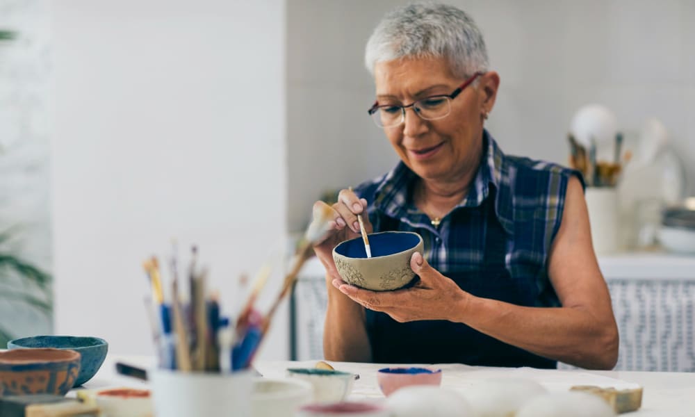 Resident painting a bowl at Randall Residence of Auburn Hills in Auburn Hills, Michigan