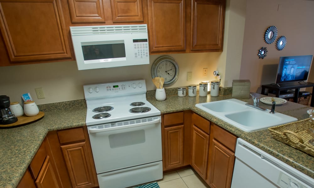 Spacious kitchen with granite countertops and light cabinetry at Villas of Waterford Apartments in Wichita, Kansas