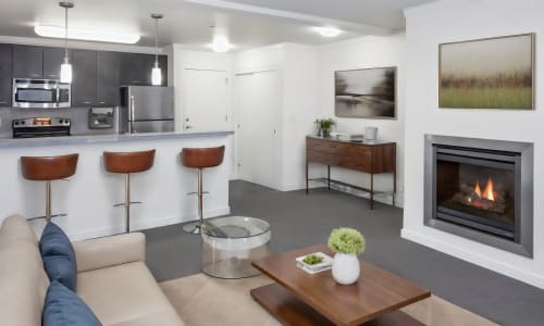 Kitchen with access to living area at Bell Tower at Old Town Square in Wilsonville, Oregon