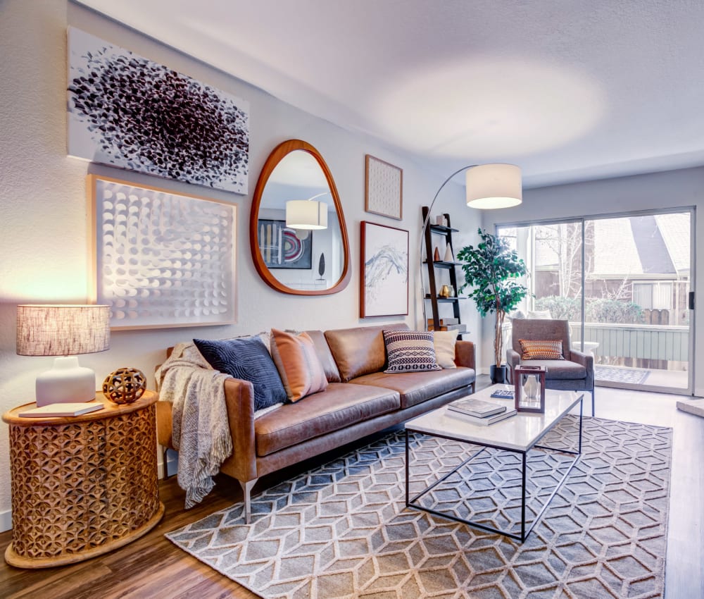 Spacious living room with wood-style flooring and patio access at Haven Martinez in Martinez, California