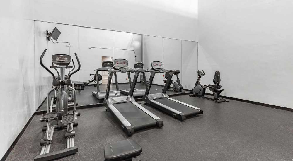 Fitness center at Preston Racquet Club Apartments in Dallas, Texas