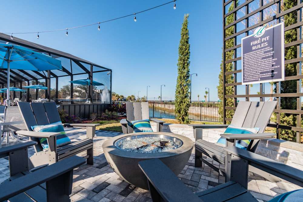 Community firepit with adirondack-style chairs at Vue on Lake Monroe in Sanford, Florida