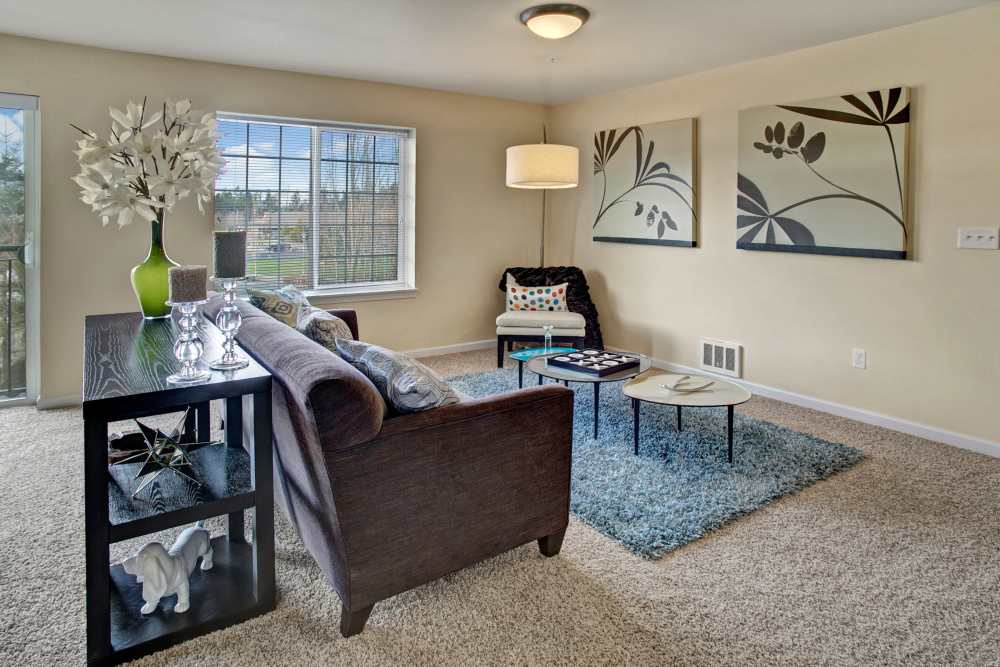 Living room with center table at Trax at Dupont Station in Dupont, Washington