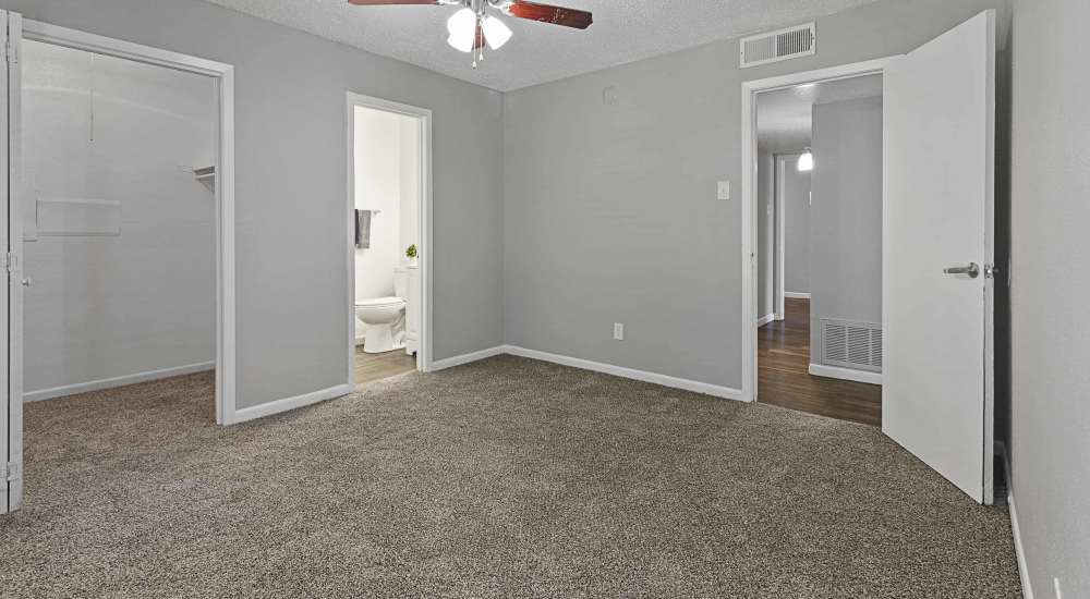 Unfurnished room with closet and bathroom access at Aria Residences in Mesquite, Texas