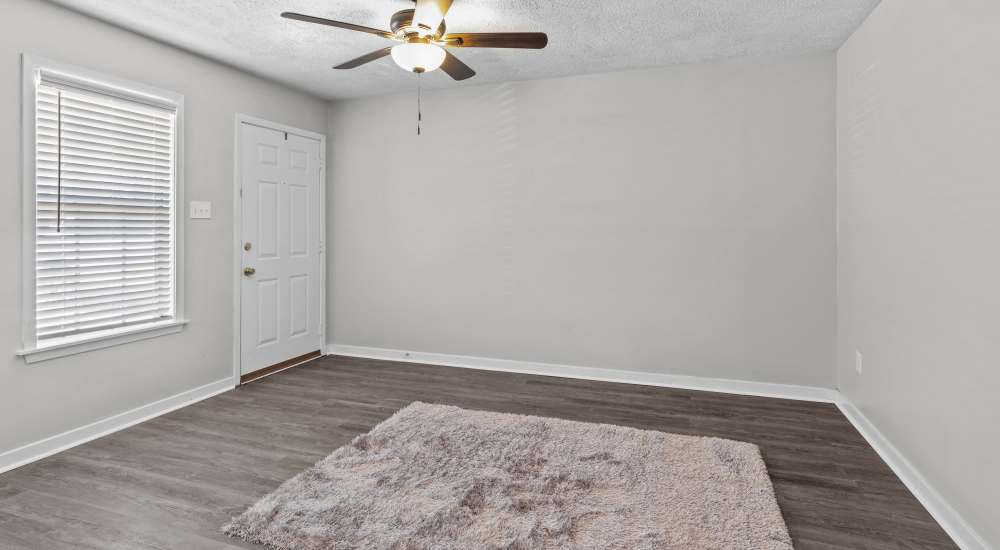 Unfurnished bedroom with large window and carpet at Pecan Ridge in Vicksburg, Mississippi