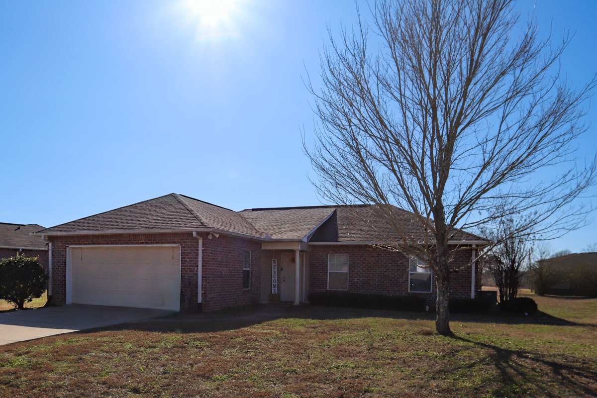 Modern brick home with garage and lawn area at Shaw Estates in Jackson, Mississippi