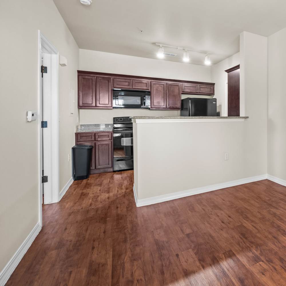 Living room with kitchen attached at Las Torres Apartments in El Paso, Texas