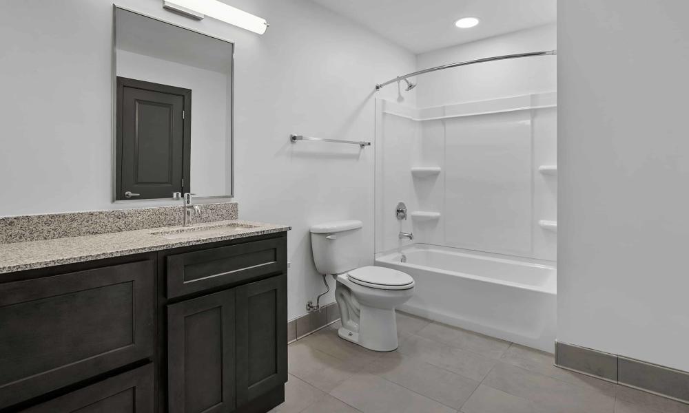 Bathroom with bathtub at The Lofts at the Municipal in Lafayette, Louisiana