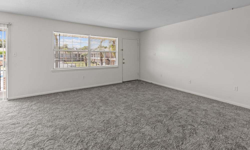 Living room with a large window and front door at Falcon House in Fort Walton Beach,Florida