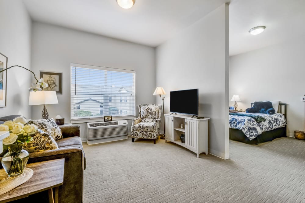 Carpeted living room and bedroom at Merrill Gardens at Sheldon Park in Eugene, Oregon 