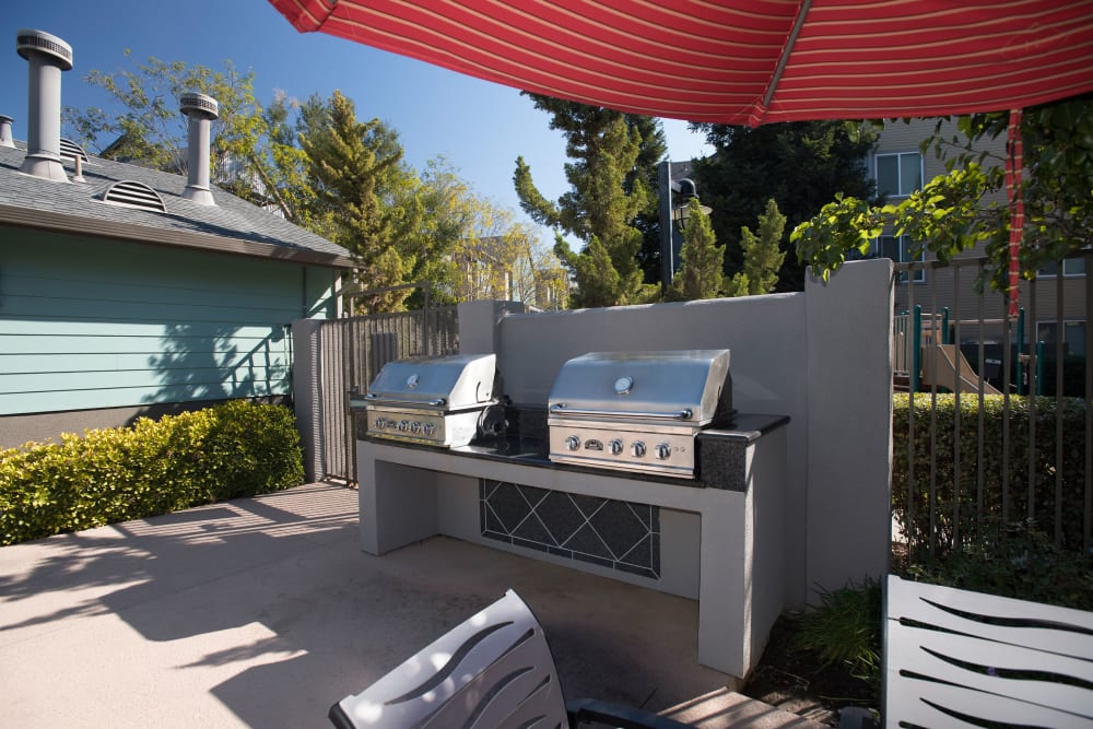 BBQ grill with tables and chairs at Azure Apartment Homes in Petaluma, California