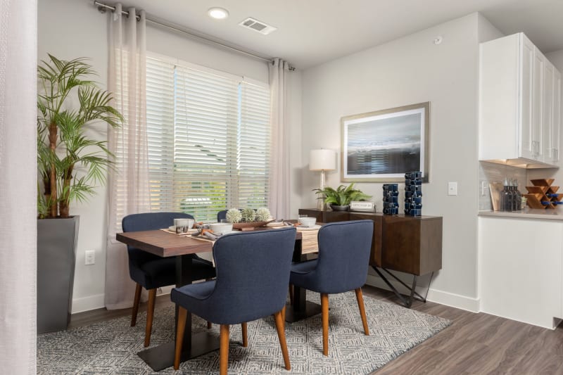 Modern dining area with wood table at Domain at Founders Parc in Euless, Texas