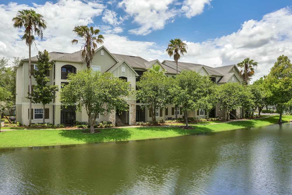 Exterior of apartment with waterbody and green meadow at Dawson in Orlando, Florida