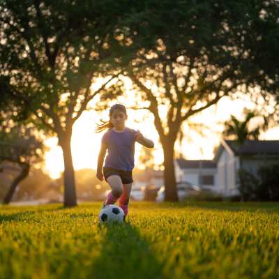 Kid playing in the park at UTE Creek Apartments in Longmont, Colorado