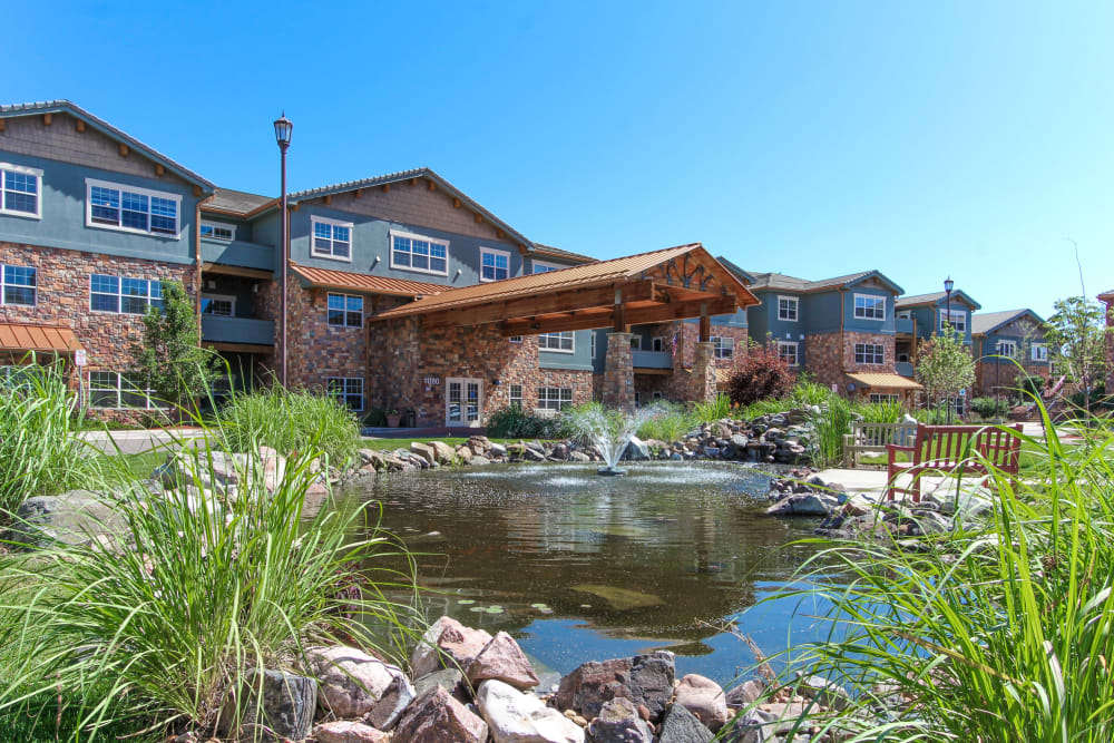 Grounds with walking paths and a pond at Keystone Place at Legacy Ridge in Westminster, Colorado