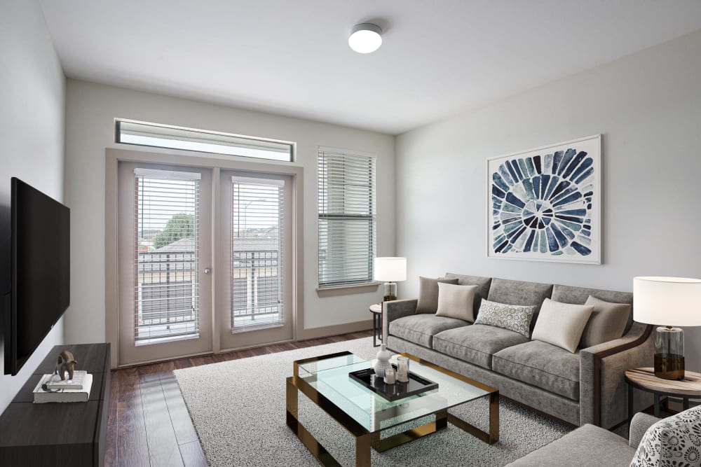 Well lit model living room at Olympus Falcon Landing in Katy, Texas