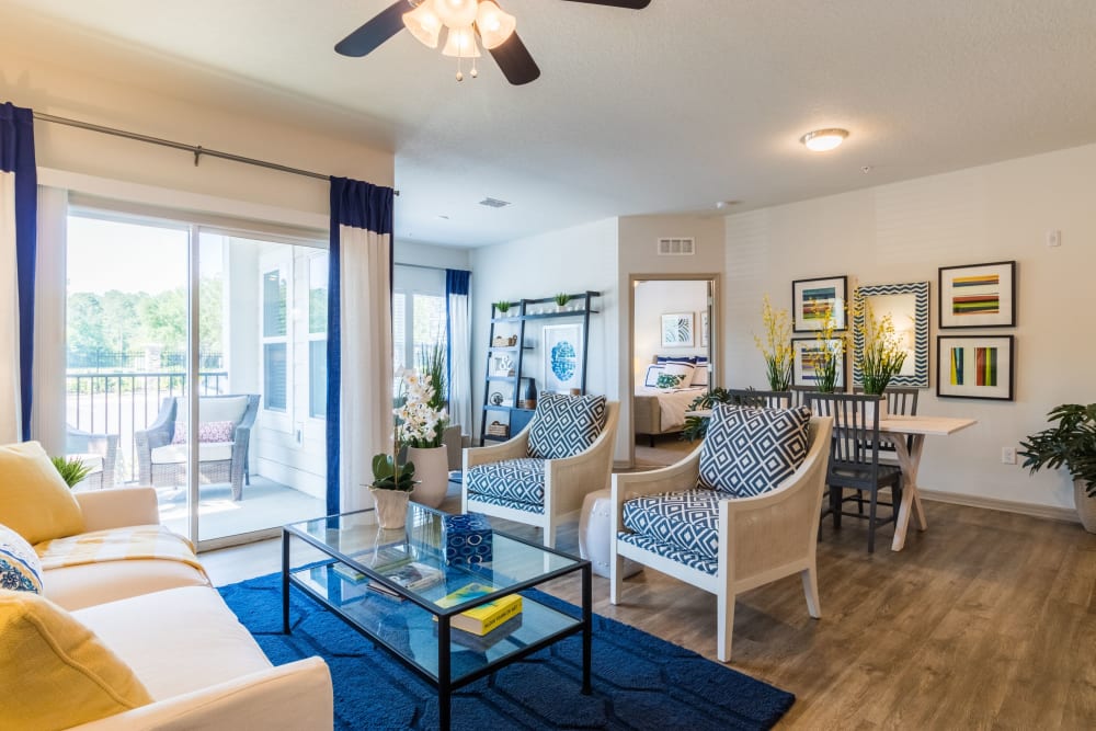 Model living room with door to balcony at Lakeline at Bartram Park in Jacksonville, Florida