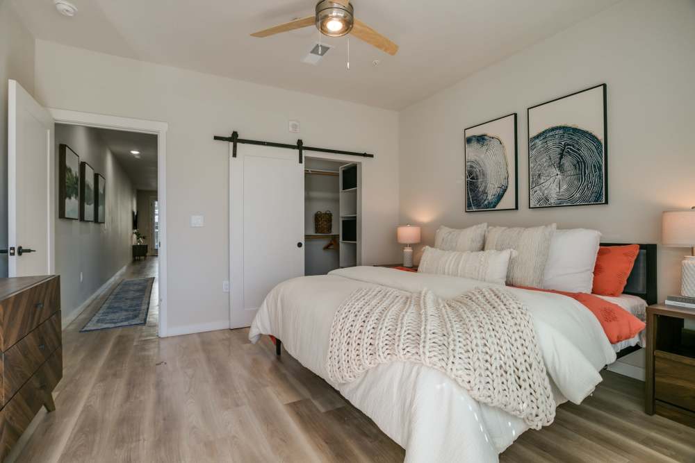 Modern bedroom with wooden flooring at Olympus Latitude in Albuquerque, New Mexico