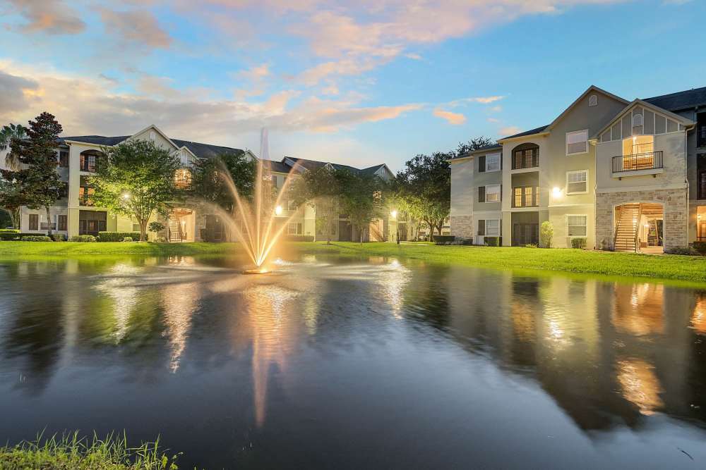 Night view of the apartment homes with water fountain at Dawson in Orlando, Florida