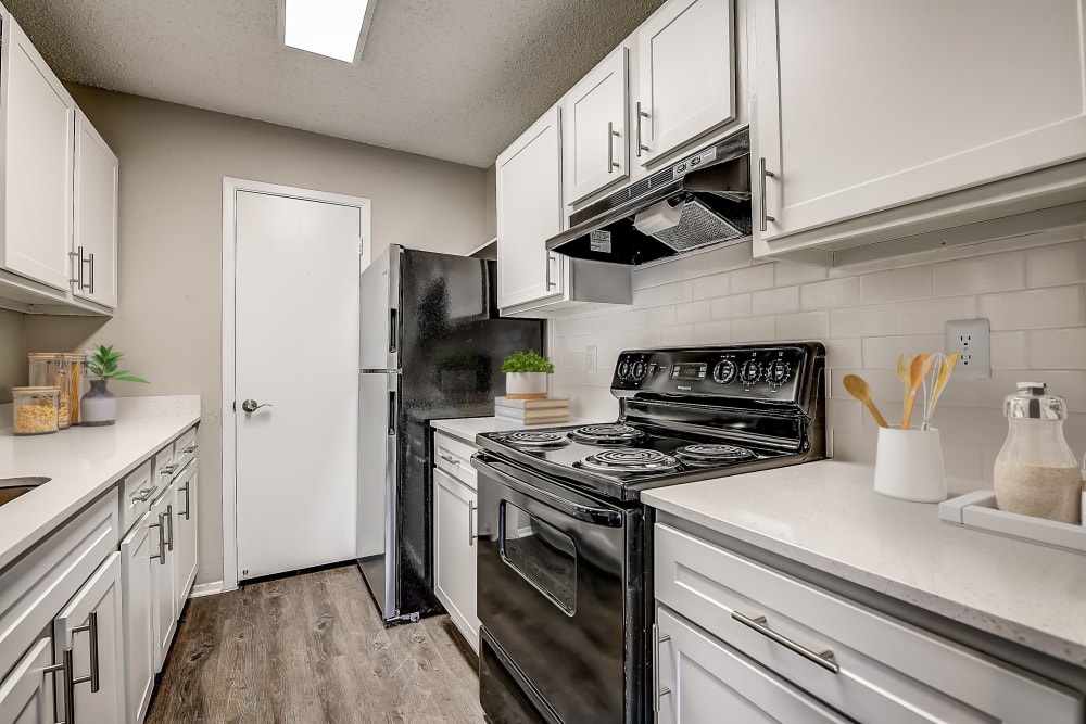 White cabinets in an apartment kitchen at Leander Apartment Homes in Benbrook, Texas