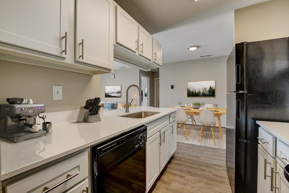 Well-lit kitchen area at Leander Apartment Homes in Benbrook, Texas