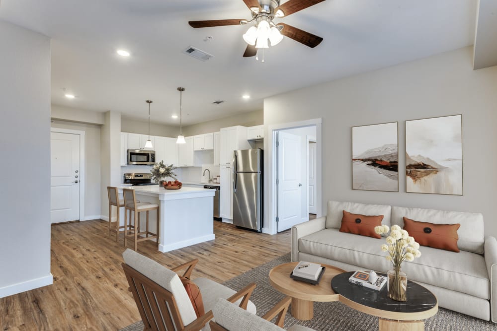 Well-furnished living room with wood-style flooring at The Trail Lakes in Fort Worth, Texas