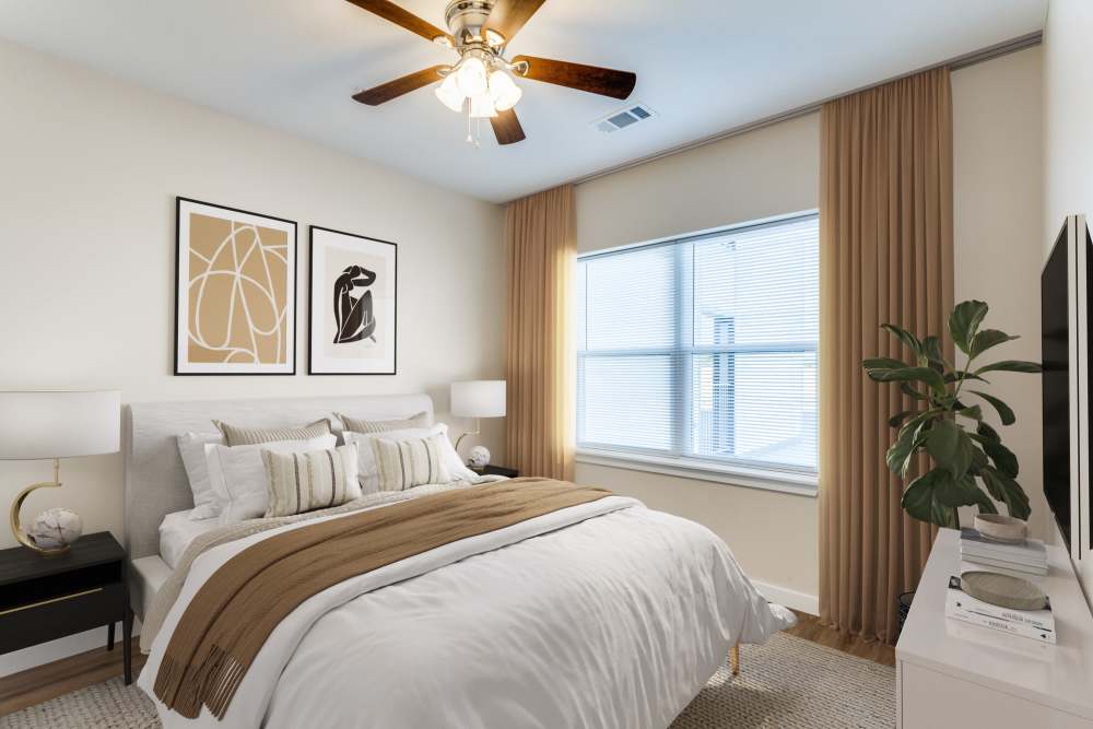 Modern bedroom with ceiling fan and a window at The Trail Lakes in Fort Worth, Texas