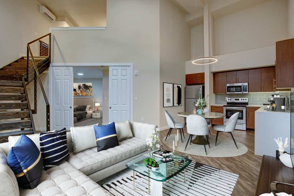 Living room with staircase at Trax at Dupont Station in Dupont, Washington